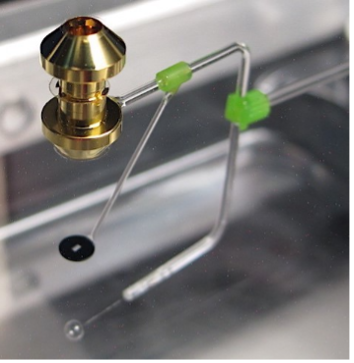 Photo of a target used in oxygen opacity experiments at LLNL’s National Ignition Facility. Glass stalks hold a gold hohlraum to heat an oxygen-rich sample, which is then backlit by x-rays from the laser-driven implosion of the plastic shell underneath. This projects an absorption spectrum to a diagnostic (not shown).
