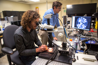 At LLNL’s HEDS Technology Facility, physicists Marius Millot (left) and Dayne Fratanduono prepare targets for shock compression experiments.