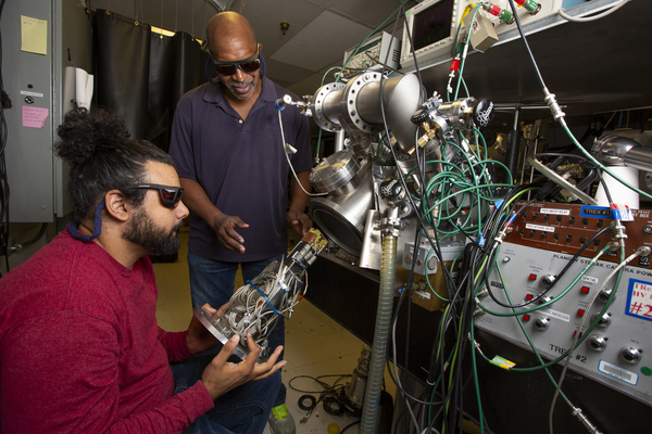 UCSD graduate students Sophie Parsons and Ross Turner prepare targets for use on Livermore’s compact ultrafast laser system.